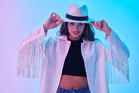 Denim Fashion, Western style. Portrait of a charming smiling girl with long hair, in the style of...