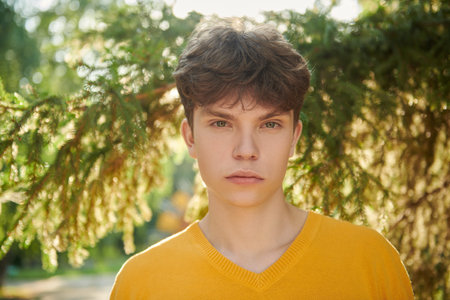 People, life moments, emotions. Summer time. Portrait of a handsome young man in a yellow pullover...