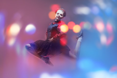 Beautiful professional dancer woman in national Irish costume makes a high jump during the dance....