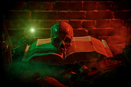 Scary objects in a room of a wizard with old scripts. Halloween. Horror novel, fantasy.の写真素材