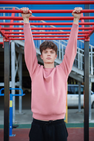 Sports and outdoor activities. A handsome young man is standing on a street sports ground near a shopping mall. Urban lifestyle.の写真素材