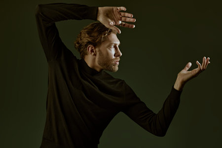 People and  emotions. Art portrait in a dark key of a handsome forty-year-old man with curly hair,...