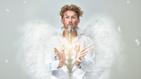 The majestic Archangel stands guard with a sword in his hands in front of him. White background....