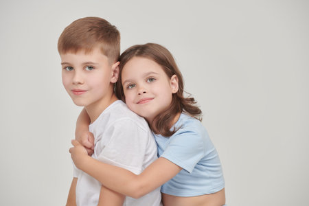 Happy family concept. Cheerful children - siblings together.  Studio portrait on a white background. Space for text. Emotions.の写真素材