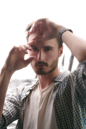Portrait of a handsome thoughtful man looking at the camera. Thoughts and contemplation. Men's...