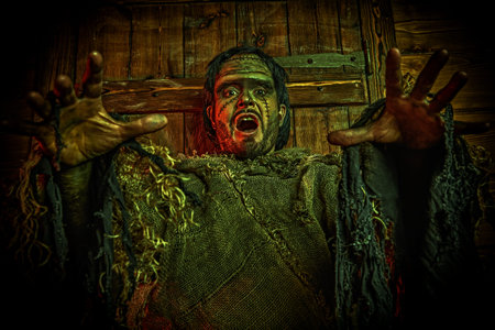 Halloween. A scary bearded man with scars on his face, dressed in burlap clothes, looking at the...
