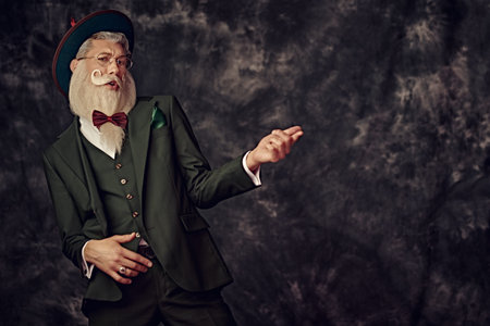Fashion and Christmas, New Year. Portrait of a handsome Santa Claus with an elegant white beard and...
