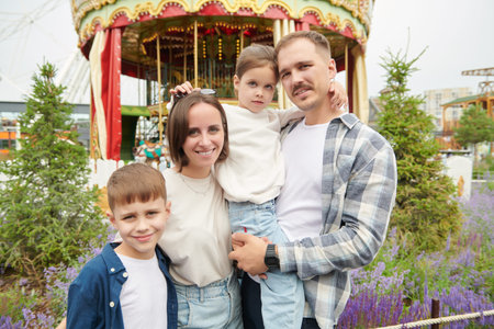 Summer time and holidays. A cheerful friendly family of parents and two children relax in the summer...