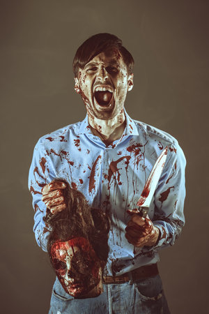 A cruel man - a murderous maniac - in a bloody shirt stands with a large bloody knife and screams...