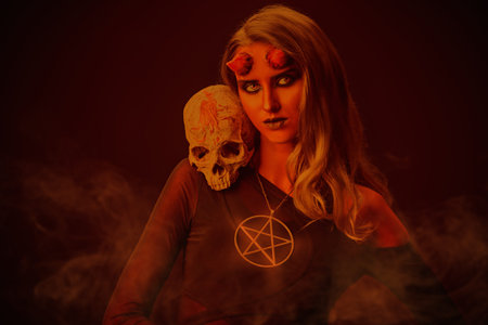Portrait of a scary and attractive devil girl with colorless eyes, dressed in black sexy lingerie,...