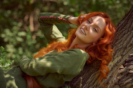 Portrait of a beautiful young woman  with magnificent long red hair in a historical celtic dress in...