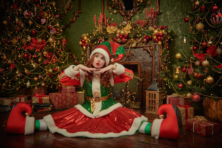 Christmas stories. Cheerful girl fairytale elf has fun on the floor in a beautiful fairytale...