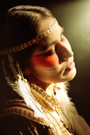 History. Ethnic culture of America. Portrait of a beautiful American Indian girl in traditional...