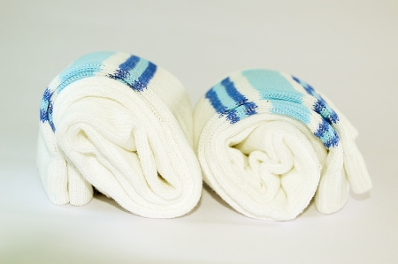 Rolled Two socks having multiple folds on white background  The texture and stripes match each other  の写真素材