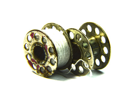 Two reels show some thread and are isolated on white  