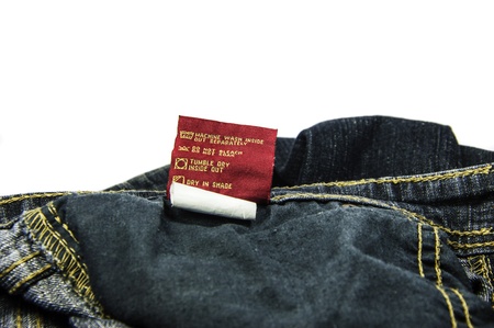 Instractions for machine wash and dry-cleaning the jeans  Information on tag attached to cloth  の写真素材