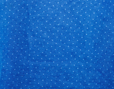 White polka dots on blue fabric 