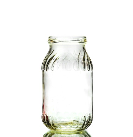 Single jar on white surface with light on bottom の写真素材