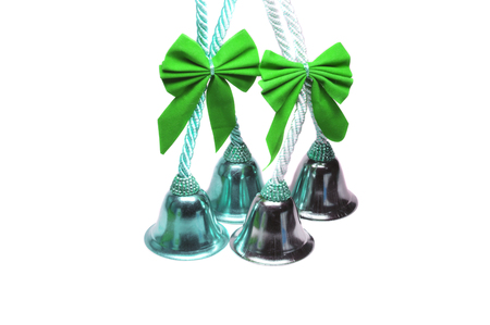 Four real christmas bells with green ribbon bow on white background.


の写真素材