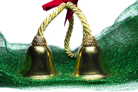 Two yellow bells on green mat or mesh.の写真素材