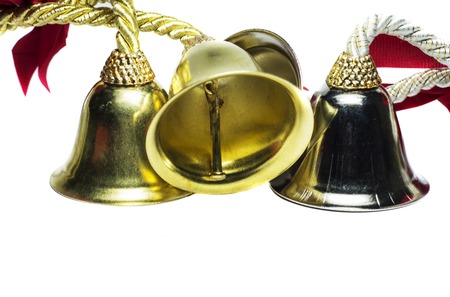 Four christmas bells with shinny metal feel on white background の写真素材