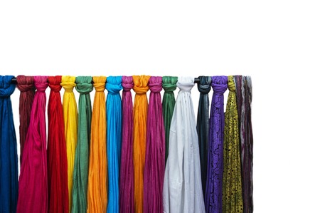 Nice scarves on sale at a shop. Scarves isolated on white background.の写真素材