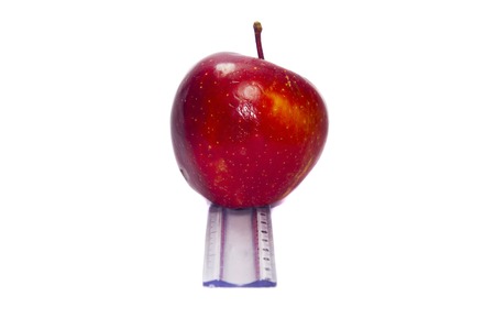 Appler on the measuring scale. Conceptual image showing progress on weightloss.の写真素材