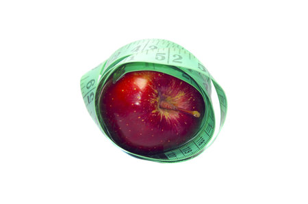 Apple wrapped in measuing tape. Showing the weightloss program and concept. 