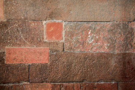 Red stone wall having retro look and having texture.