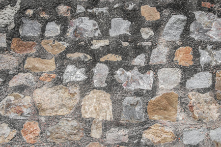 Wall of black, white and red stones  These rocks are small and big forming a wall の写真素材