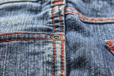 Side pockets of jeans which is showing different colored stitching. 