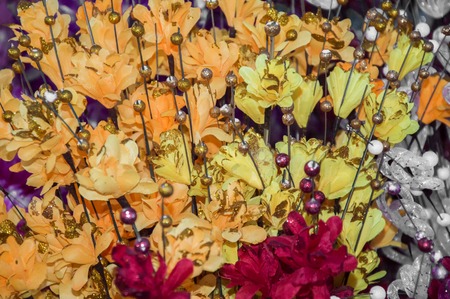Fabric flowers and other artificial ones of different colors.の写真素材