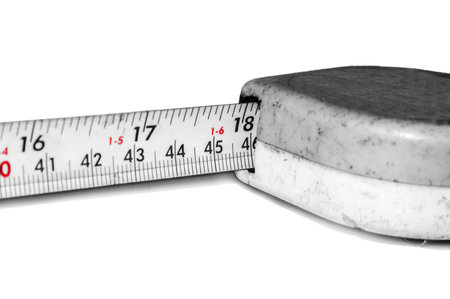 Measuring tape of red signs on black letters.