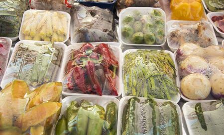 Packed and wrapped vegetables on plastic tray and with sheetの写真素材