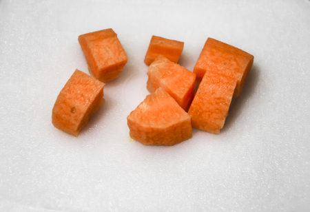 Slices of carrot on the white surface.の写真素材