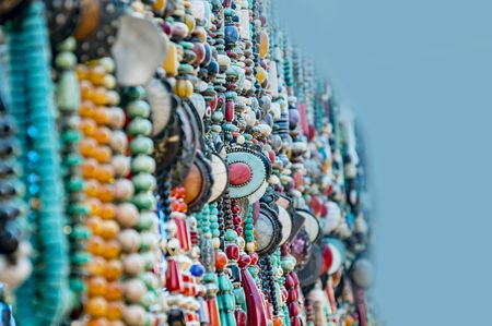 Different beaded necklaces on display and for saleの写真素材