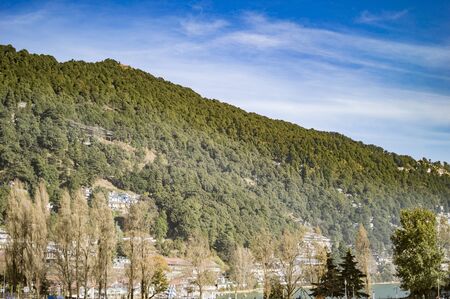 Smoke in the mountain town with houses on the banks of nainital lake.の写真素材