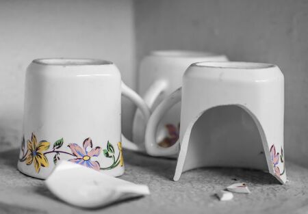 Cups and broken unit among the other mugs.の写真素材