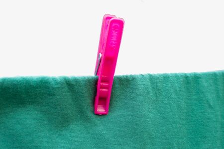 Pink clothsping on string and cloth.の写真素材