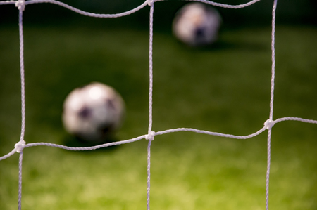 Soccer net with ball at other side of the stringsの写真素材