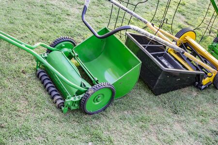 Mechanical lawn mower of green and yellow colorの写真素材
