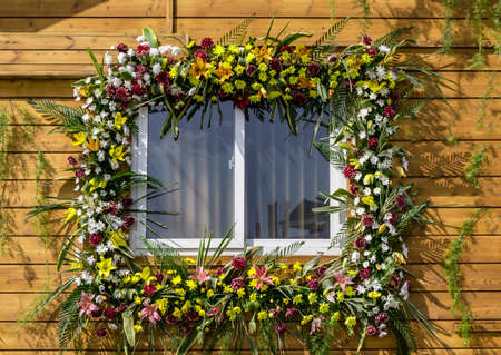 Decorated window with flowers and leavesの写真素材