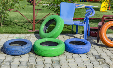 Old chairs and painted tires for playing and recreational activities.の写真素材
