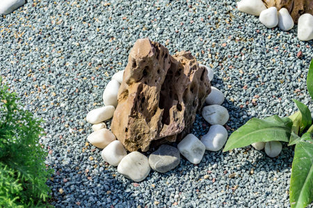 Rocks art with stones placed around it on the ground.