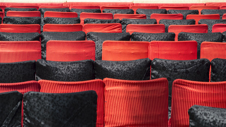 Empty chairs of red and black colors in auditoriumの写真素材