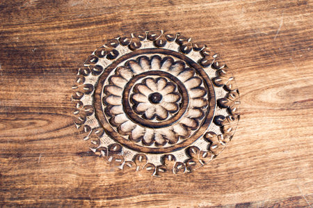 Design  of round flower on hard wood which has been carvedの写真素材