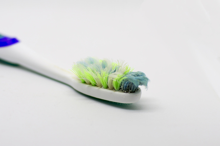 Badly used toothbrush with threads of plasticの写真素材