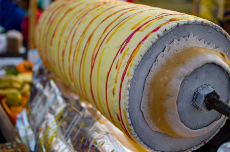Fruit roller ice cream drum with frozen layers of flavors