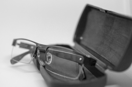 Eye-glasses with cover on black frame and surfaceの写真素材