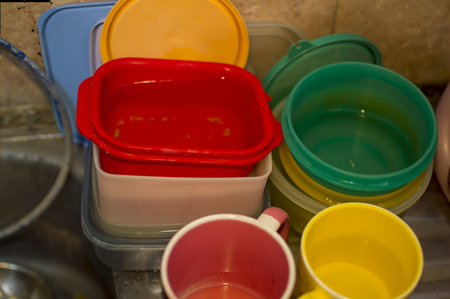 Plastic dirty utensils in the sink for cleaning and washingの写真素材